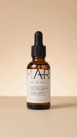 MARI Hair Oil bottle on a warm beige background